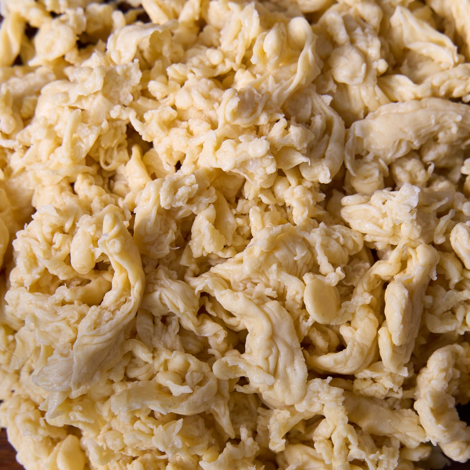 Close-up of NoEgg Fibers: loose, pale-golden lupin strands