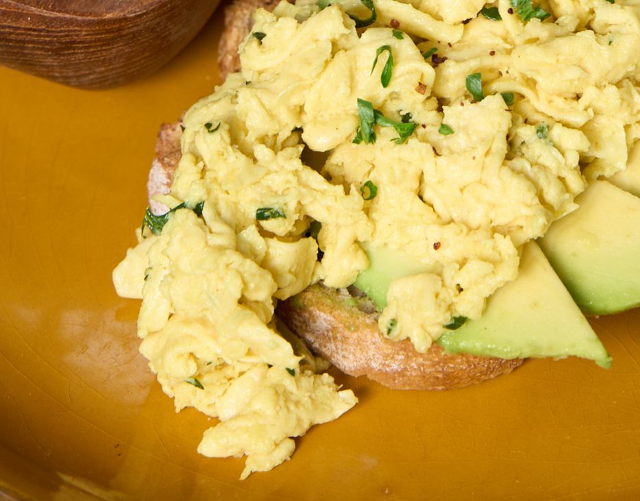 NoEgg Scramble on toast with fanned avocado slices
